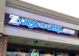 The exterior storefront of Zorba The Greek Express in Coram, NY